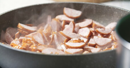 Unhealthly cooking frying sausages