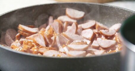 Sausage cuts frying on pan