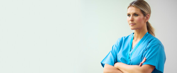 Portrait Of Mature Female Doctor Wearing Scrubs In Hospital