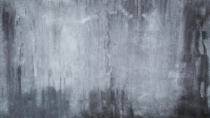 A gray grunge picturesque wall texture with stains and scratches on concrete surface 
