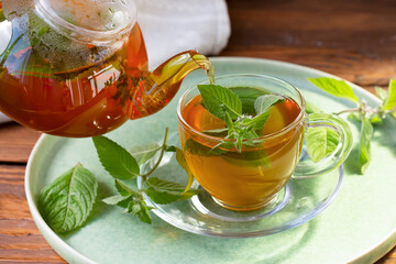 Green tea with mint in a transparent bowl. Healthy food, antioxidants.