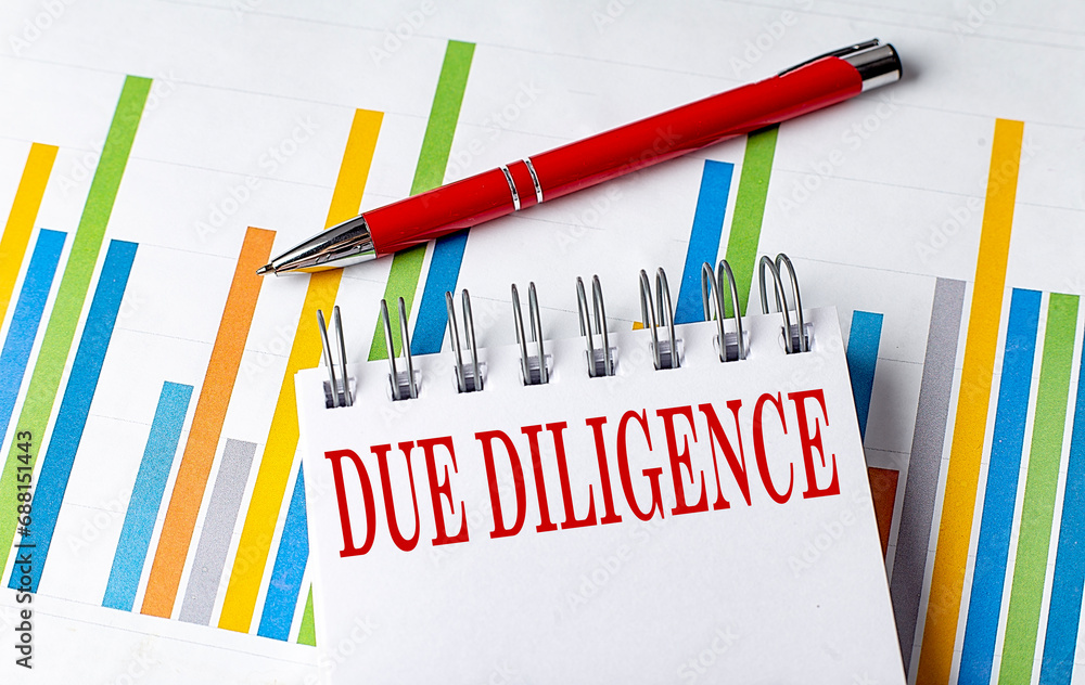 Poster due diligence text on a notebook with chart and pen business concept