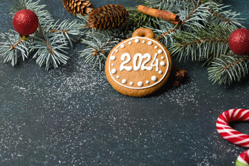 Gingerbread cookies of the form of numbers and 2024. Christmas composition with gingerbread on dark background. Copy space