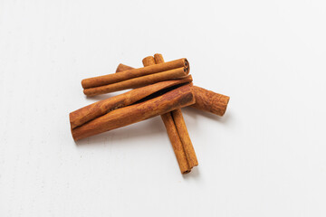 All the cinnamon is on the pile, the background is white. Flatlay photography