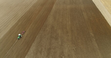 Obraz premium Agriculture- Tractor plowing GMO Free agricultural field.