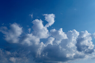 Naklejka na ściany i meble Cumulus clouds in the blue sky close-up, among the clouds