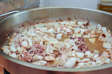 in the process of making a black rice with squids