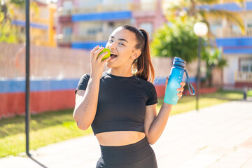 woman with apple and water at outdoors