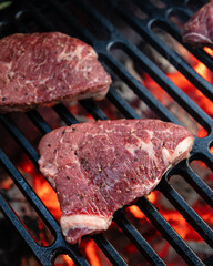 Beef rumpsteak cooked on a cast iron grate on a charcoal grill