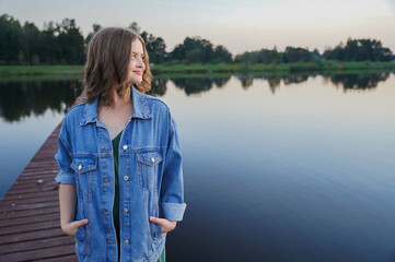 Fototapeta premium Romantic portrait of beautiful teenager girl on summer sunset time. Travel and leisure, vacation and freedom concept.