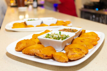 empanada colombiana on a plate with chili