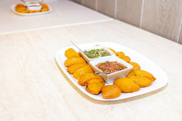 empanada colombiana on a plate with chili