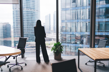 Anonymous businesswoman standing in modern office