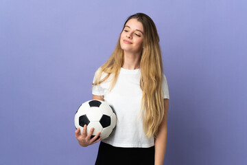 Young blonde football player woman isolated on purple background looking to the side and smiling