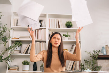 Young woman very stressed while working in home office. Businesswoman tired and sitting at working place.