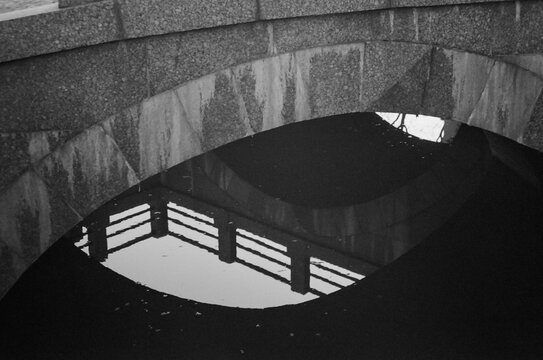 Reflection of a bridge in calm water - film photography