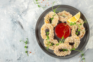 Fototapeta na wymiar fried squid rings breaded with lemon. banner, menu, recipe copy space, top view