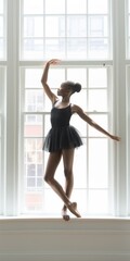 Graceful African American Ballerina Dancing on Windowsill in Black Dress
