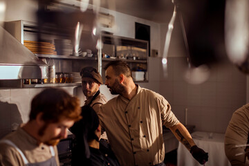 Professional Chefs Preparing Food Together in a Busy Restaurant Kitchen