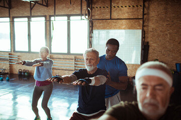 Senior fitness class with personal trainer at the gym