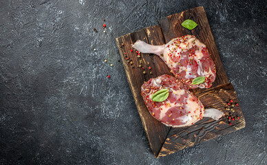 Fresh duck leg meat on a dark background. top view. copy space for text