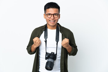 Young Ecuadorian photographer isolated on white background celebrating a victory in winner position