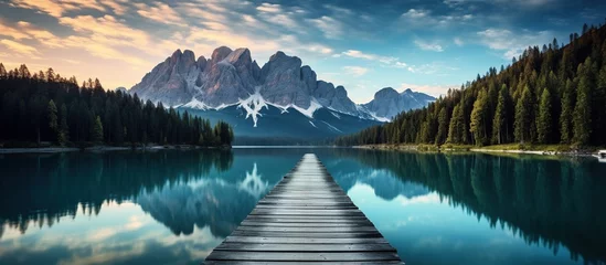 Poster Empty Wooden pier Morning landscape of autumn picturesque mountain lake in Dolomites. © Penatic Studio