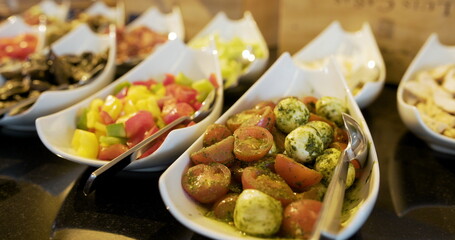 italian food - several fresh salads and vegetables on plate.