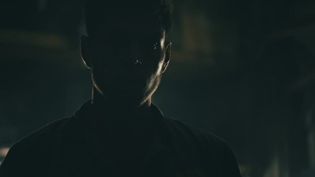 Man standing in silhouette in a dark room. 4K
