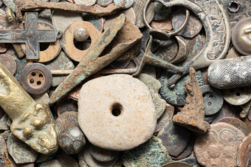 A collection of antique iron relics, including coins, arrowheads, nails, bullets, and a cross,...