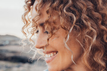 Close up side view portrait of happy woman with serene expression smiling and enjoying life outdoor leisure activity alone. Adult caucasian female people happy thoughts and enjoying life in outdoors - Powered by Adobe