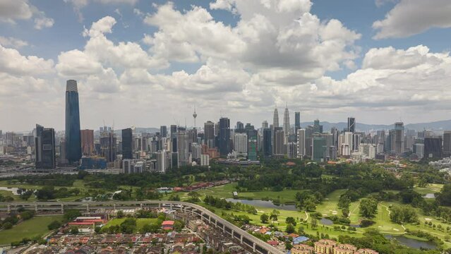 day time flight over kuala lumpur cityscape downtown golf course traffic road aerial panorama 4k timelapse malaysia
