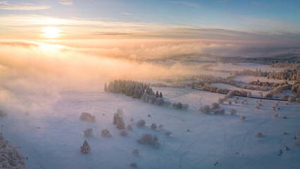 Sunset over the low hanging clouds and the beautiful winter landscape