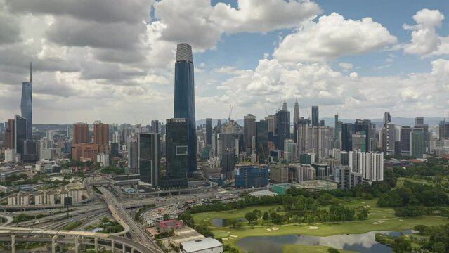day time flight over kuala lumpur cityscape downtown golf course traffic road aerial panorama 4k timelapse malaysia