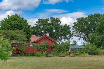 Villa cottage in countryside rural area. Beautiful old traditional last century house. Red wooden house view. Outdoor recreation area in the courtyard of a country house.