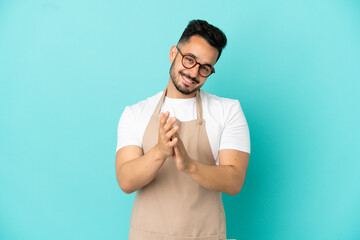 Restaurant waiter caucasian man isolated on blue background applauding after presentation in a conference