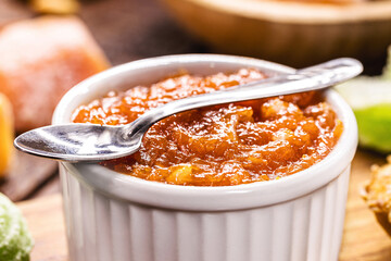pot with pumpkin pudding, homemade pumpkin jam in a rustic setting, typical rural dessert of Brazilian redneck parties in June