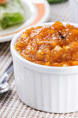Brazilian pumpkin jam or pudding, with candied pumpkin jam in the background, tradition of the Brazilian June festivals