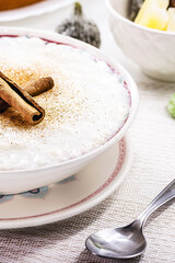 rice pudding bowl, homemade pudding made from ground rice, sweet with cinnamon powder and cinnamon bark.