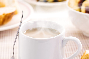 milk with coffee, traditional Brazilian breakfast drink, served hot with bread and toast