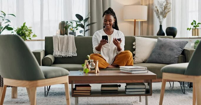 Happy, black woman and credit card with phone on sofa for online shopping, payment code and fintech at home. Mobile banking, finance and password to upgrade subscription, ecommerce and money savings
