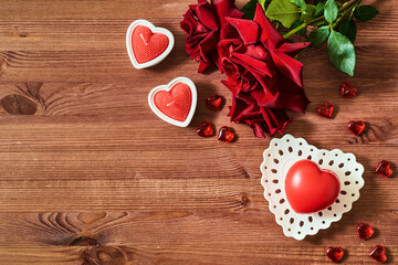 Valentines day frame with heart and red roses, candles  on a wooden background. Valentines day banner with copy space