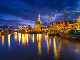 Fototapeta na wymiar Hoorn, Netherlands. An ancient harbor and marina. Old sailing ships. View of houses during evening. A cityscape in the evening. Postcard, background, wallpaper.