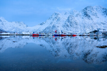 Boats on Lofoten islands, Norway. Mountains and reflection on water surface. Evening time. Winter landscape near the ocean. Norway travel - obrazy, fototapety, plakaty