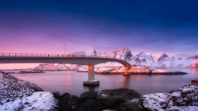 View on the bridge in the Hamnoy village, Lofoten Islands, Norway. Landscape in winter time during blue hour at sunrise. Mountains and water. Travel image