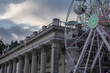 Kyiv, Ukraine. 04.12.2023: The glowing Ferris wheel near the building on VDNG