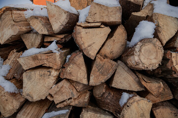 KYIV, UKRAINE - DECEMBER 6, 2023: ON THE TERRITORY OF VDNG, FIREWOOD IS COVERED BY SNOW TO LIGHT BONNETS AND WARM AFTER THE OPENING OF THE NEW YEAR FAIR