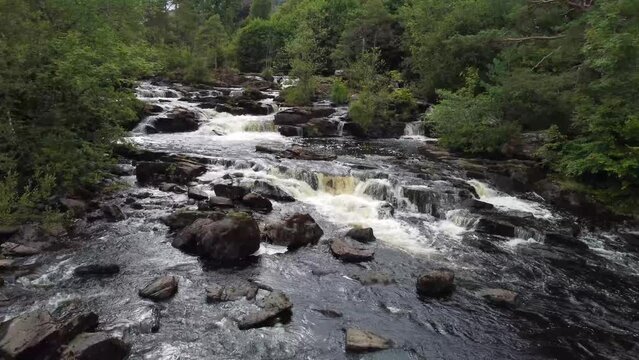 Drone flying closely over the Falls of Dochart in Killin, Scotland.