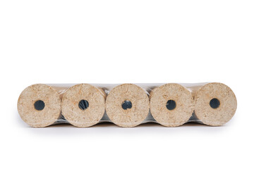 Fuel briquettes folded in rows on a white background. Wooden briquettes are an environmentally friendly fuel source that are used to start a fire. They are made by pressing of dry sawdust. - obrazy, fototapety, plakaty