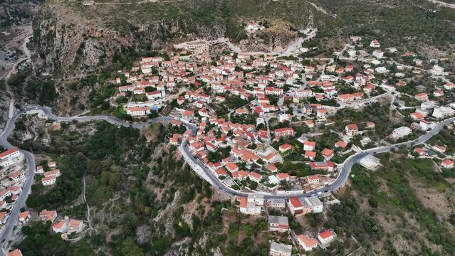 Dhermi at Sunset time. Aerial Shot of Beautiful Village Sea View, Stone Houses, beach Resort in Mountains of Albania